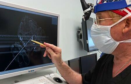 Dr. Robert Donoway scanning an image on a monitor in the surgical suite.