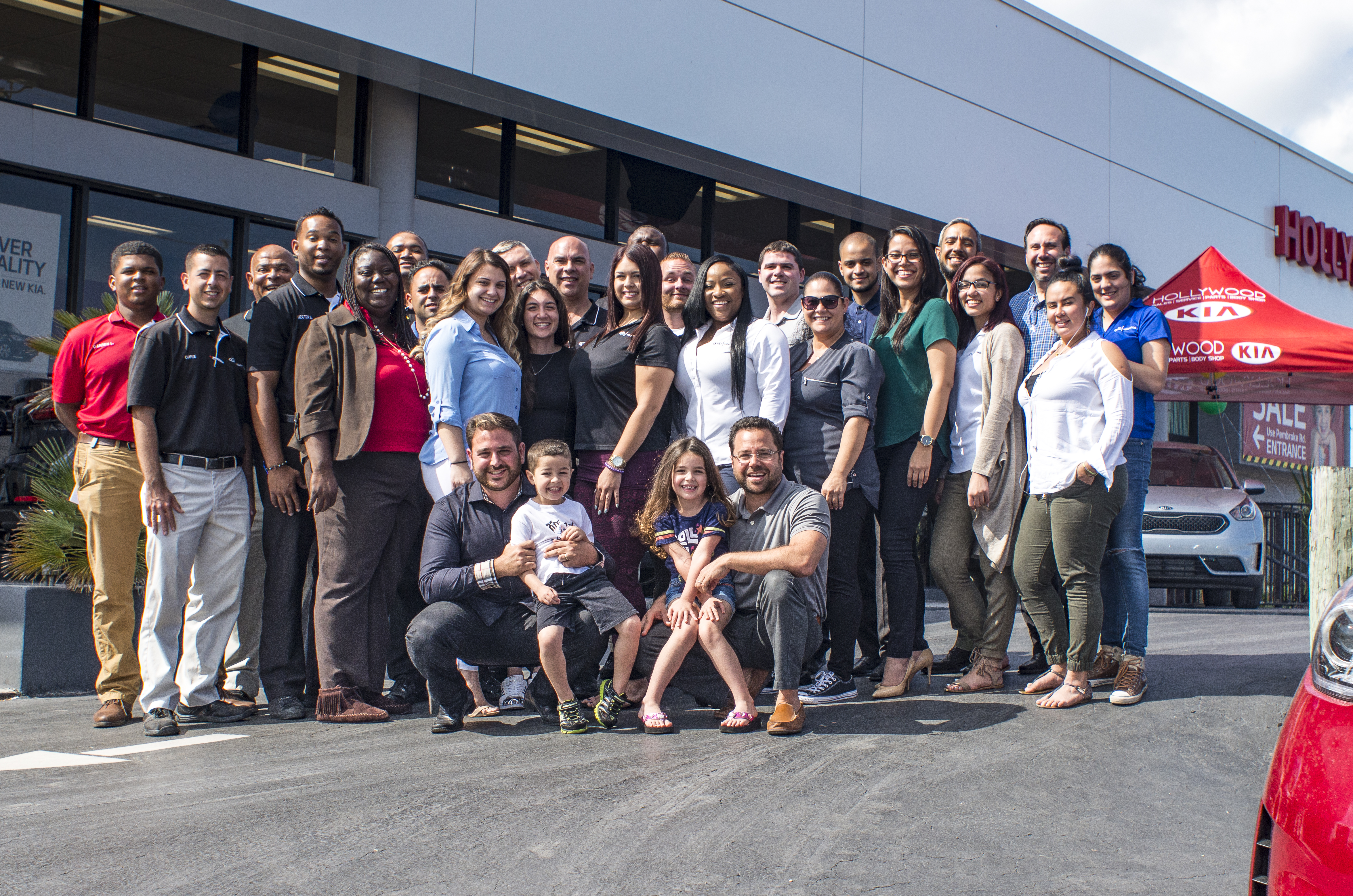 Group of employees outside Kia dealership