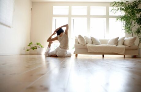 woman doing yoga on floor at home