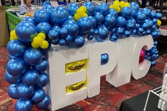 statue of the word EPIC with blue balloons around it